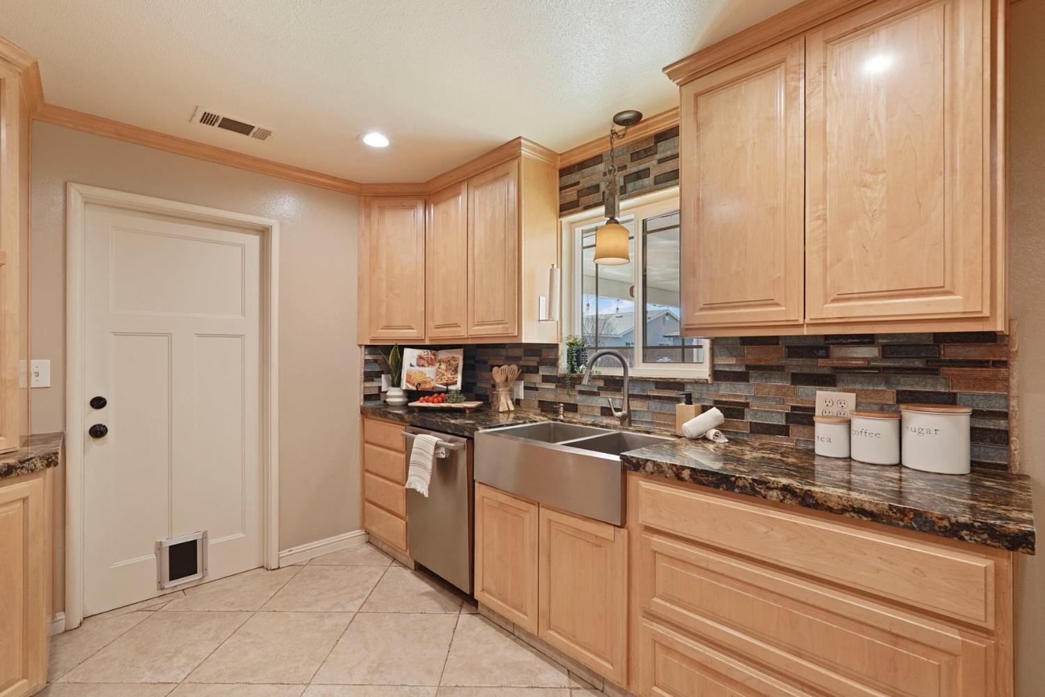 916 6th Street Ripon, CA 95366 - Photo 9 of 34 a kitchen with stainless steel appliances granite countertop a stove a sink and a refrigerator