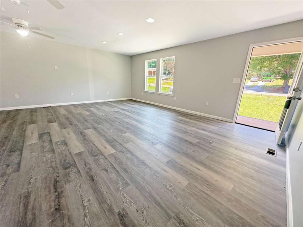 24 George Street Forsyth, GA 31029 - Photo 16 of 17 an empty room with wooden floor and windows
