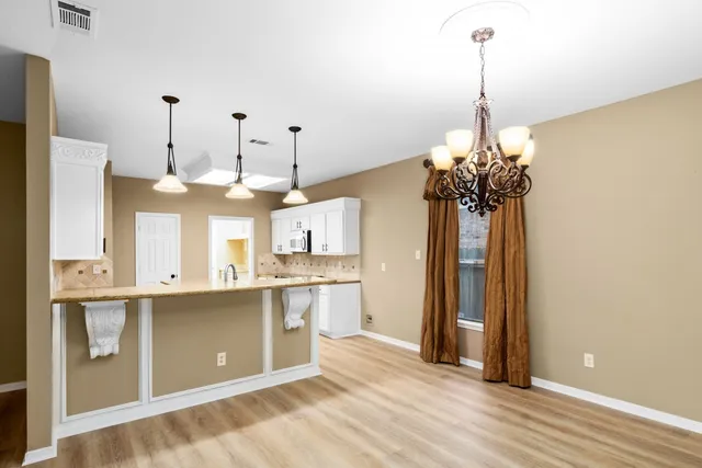 a view of a kitchen with stainless steel appliances granite countertop a stove a refrigerator and a sink