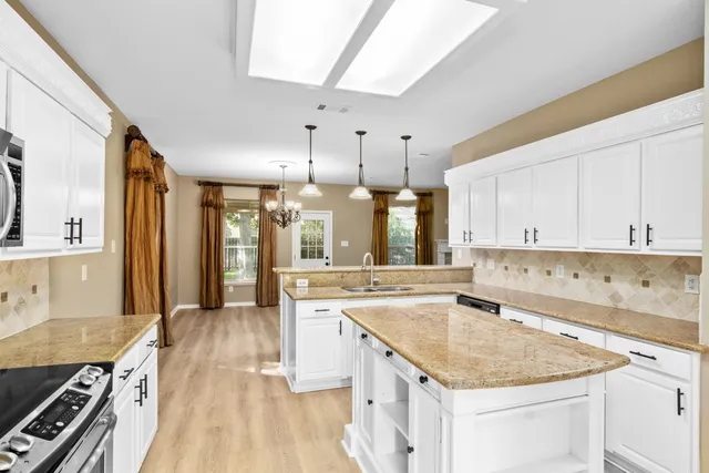 a kitchen with a stove sink and cabinets