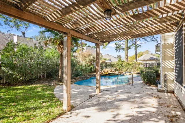 a view of a porch with a table chairs and a backyard