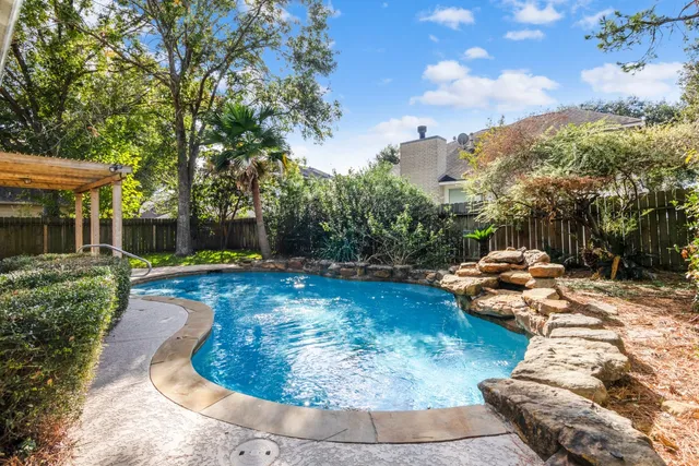 a view of a backyard with swimming pool