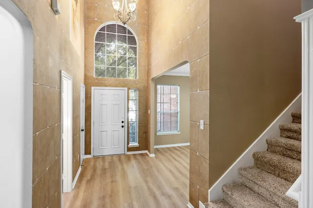 a view of an entryway with wooden floor