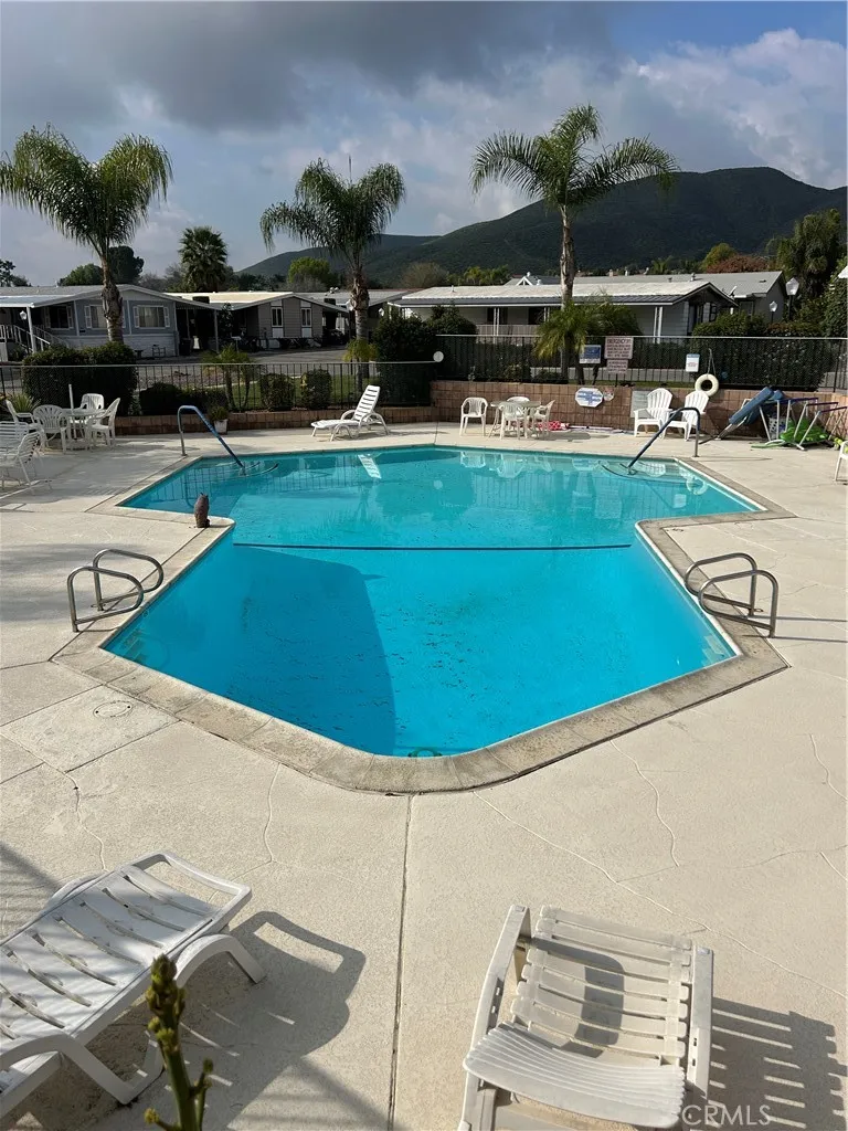 27701 Murrieta Road, Unit 228 Menifee, CA 92586 - Photo 33 of 34 a view of a swimming pool with lawn chairs