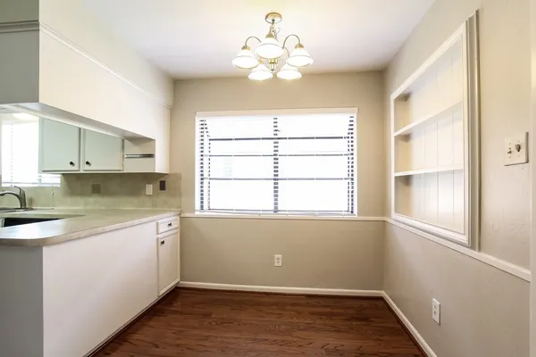 a kitchen with a window a sink and cabinets