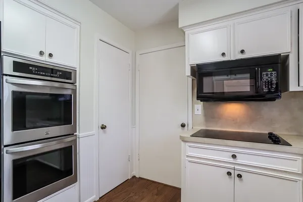 a kitchen with microwave cabinets and stainless steel appliances