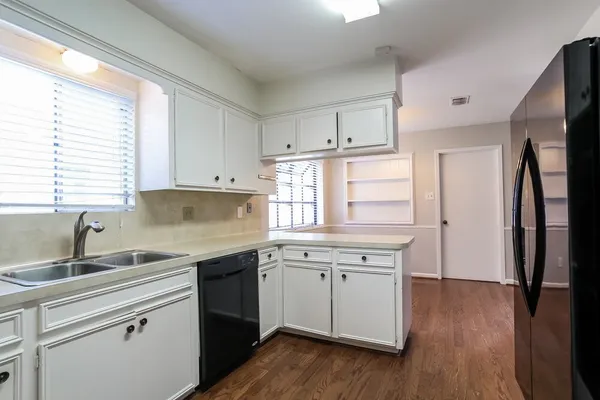 a kitchen with a sink stove and refrigerator