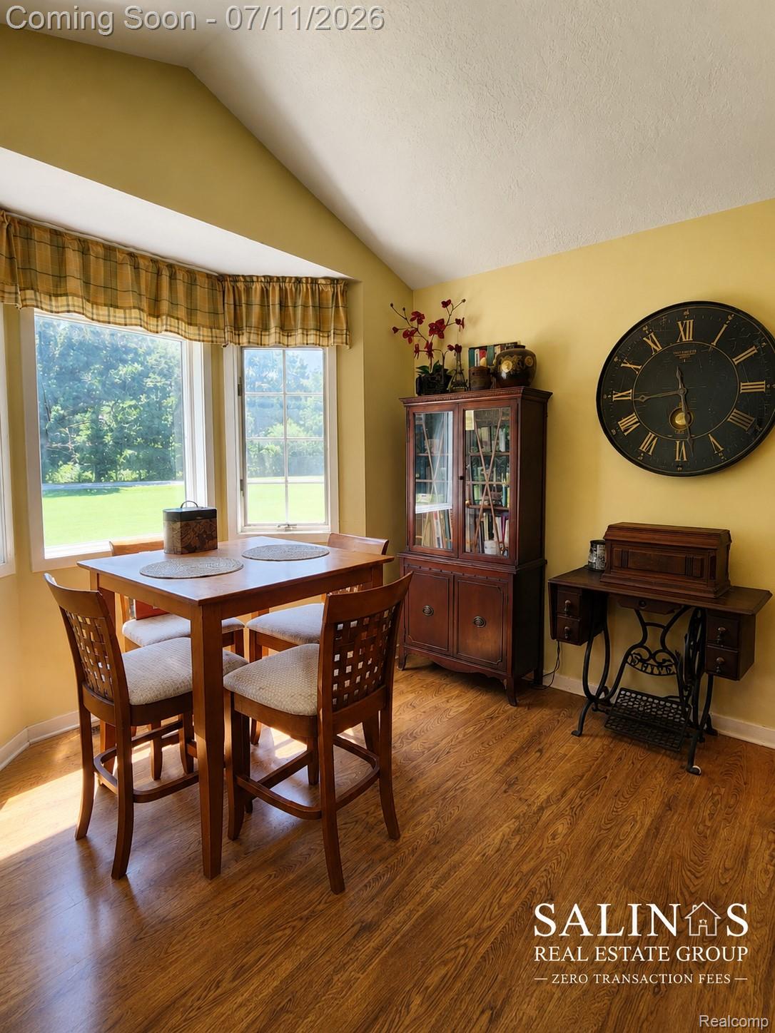 2120 Montague Road Davison, MI 48423 - Photo 26 of 37 Bay window with multiple panes, wood-finish flooring, vaulted ceiling, and painted walls