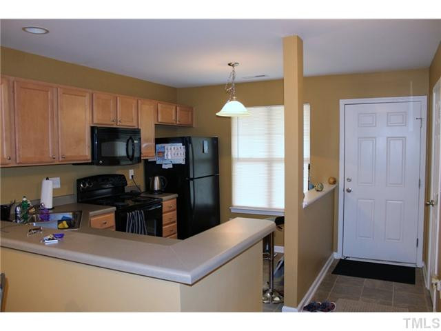 3716 Bison Hill Lane Raleigh, NC 27604 - Photo 2 of 14 a kitchen with kitchen island a counter top space a sink stainless steel appliances and cabinets