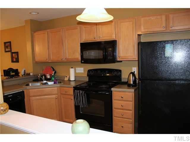 3716 Bison Hill Lane Raleigh, NC 27604 - Photo 3 of 14 a kitchen with a sink a stove and refrigerator