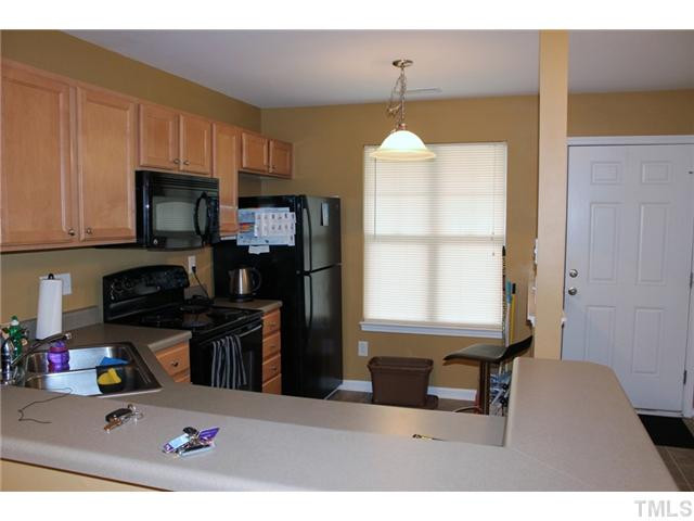 3716 Bison Hill Lane Raleigh, NC 27604 - Photo 4 of 14 a kitchen with a window a sink and a microwave
