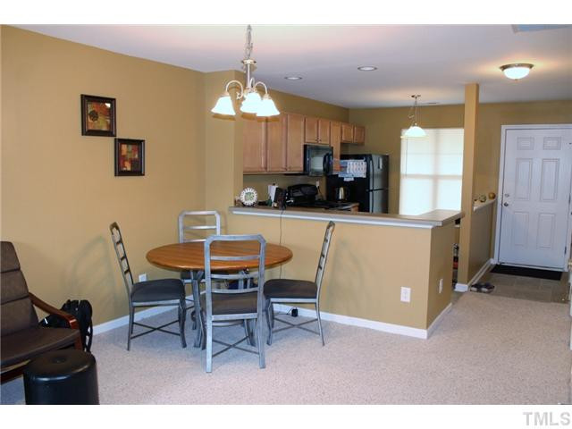3716 Bison Hill Lane Raleigh, NC 27604 - Photo 5 of 14 a view of a dining room with furniture and a chandelier
