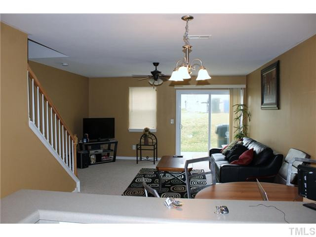 3716 Bison Hill Lane Raleigh, NC 27604 - Photo 6 of 14 a living room with furniture a flat screen tv and a large window