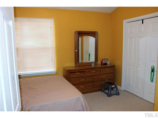 3716 Bison Hill Lane Raleigh, NC 27604 - Photo 10 of 14 a room with a bed and a dresser