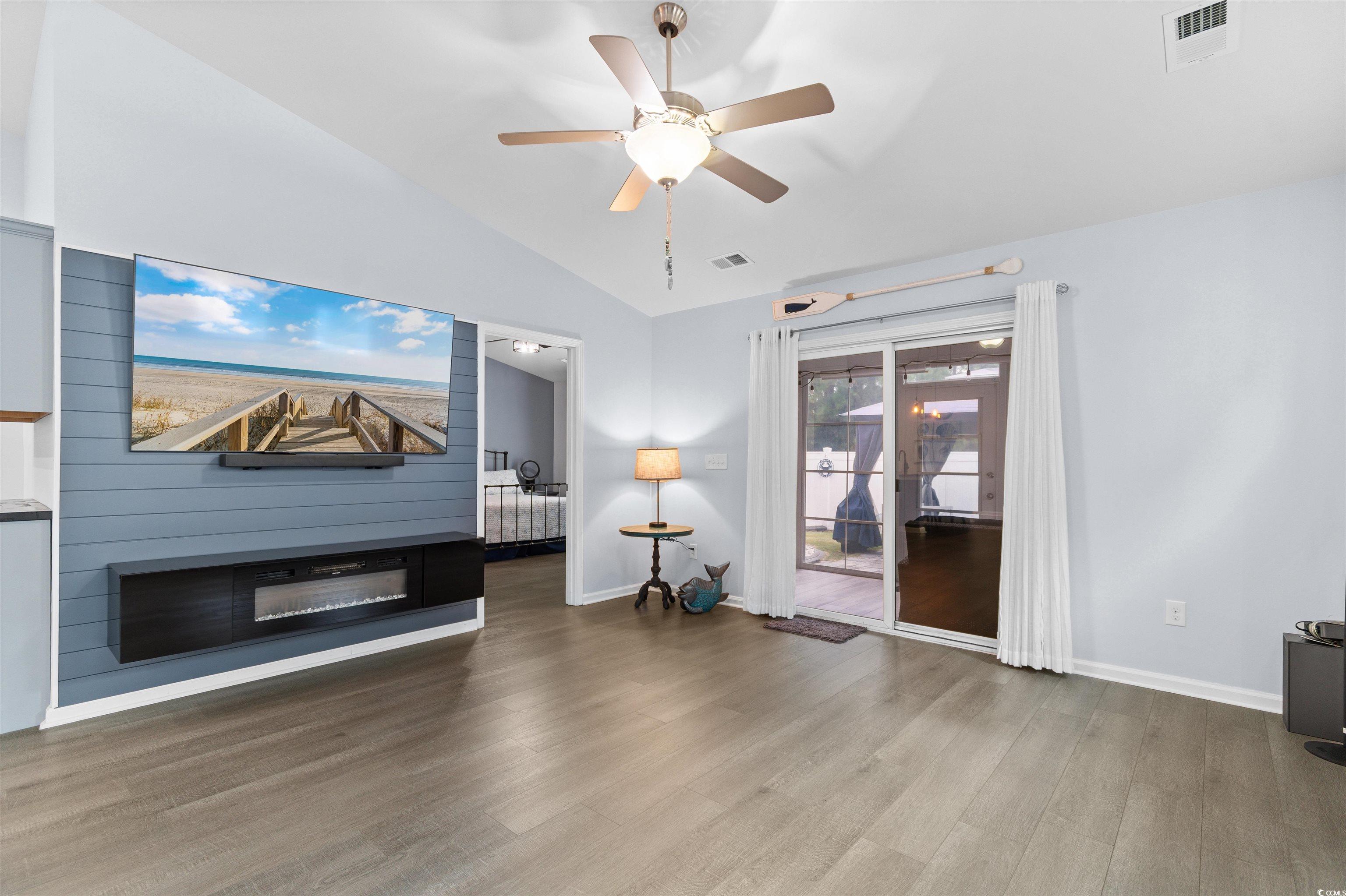 4380 Livorn Loop, Unit 4380 Myrtle Beach, SC 29579 - Photo 11 of 33 Kitchen featuring stainless steel range with gas stovetop, dark stone counters, tasteful backsplash, black refrigerator with ice dispenser, and hanging light fixtures