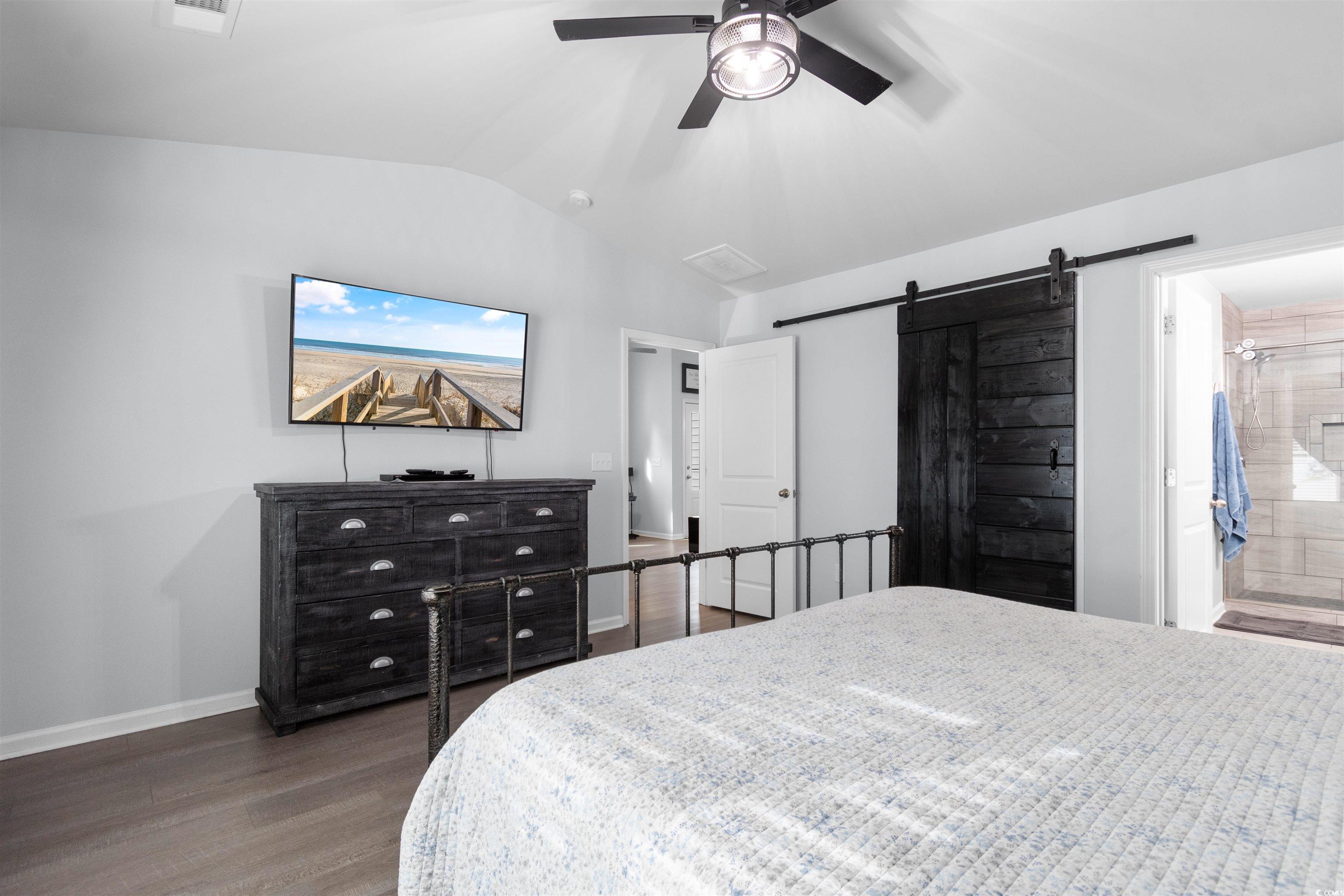 4380 Livorn Loop, Unit 4380 Myrtle Beach, SC 29579 - Photo 14 of 33 Unfurnished living room with light wood-style flooring, vaulted ceiling, a ceiling fan, and a glass covered fireplace