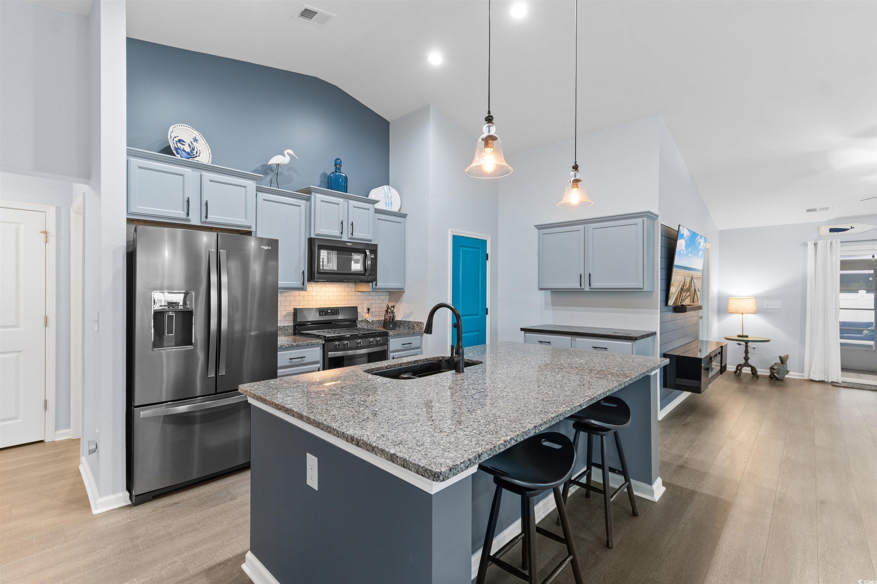 4380 Livorn Loop, Unit 4380 Myrtle Beach, SC 29579 - Photo 3 of 33 View of property exterior featuring roof with shingles, a yard, concrete driveway, and an attached garage