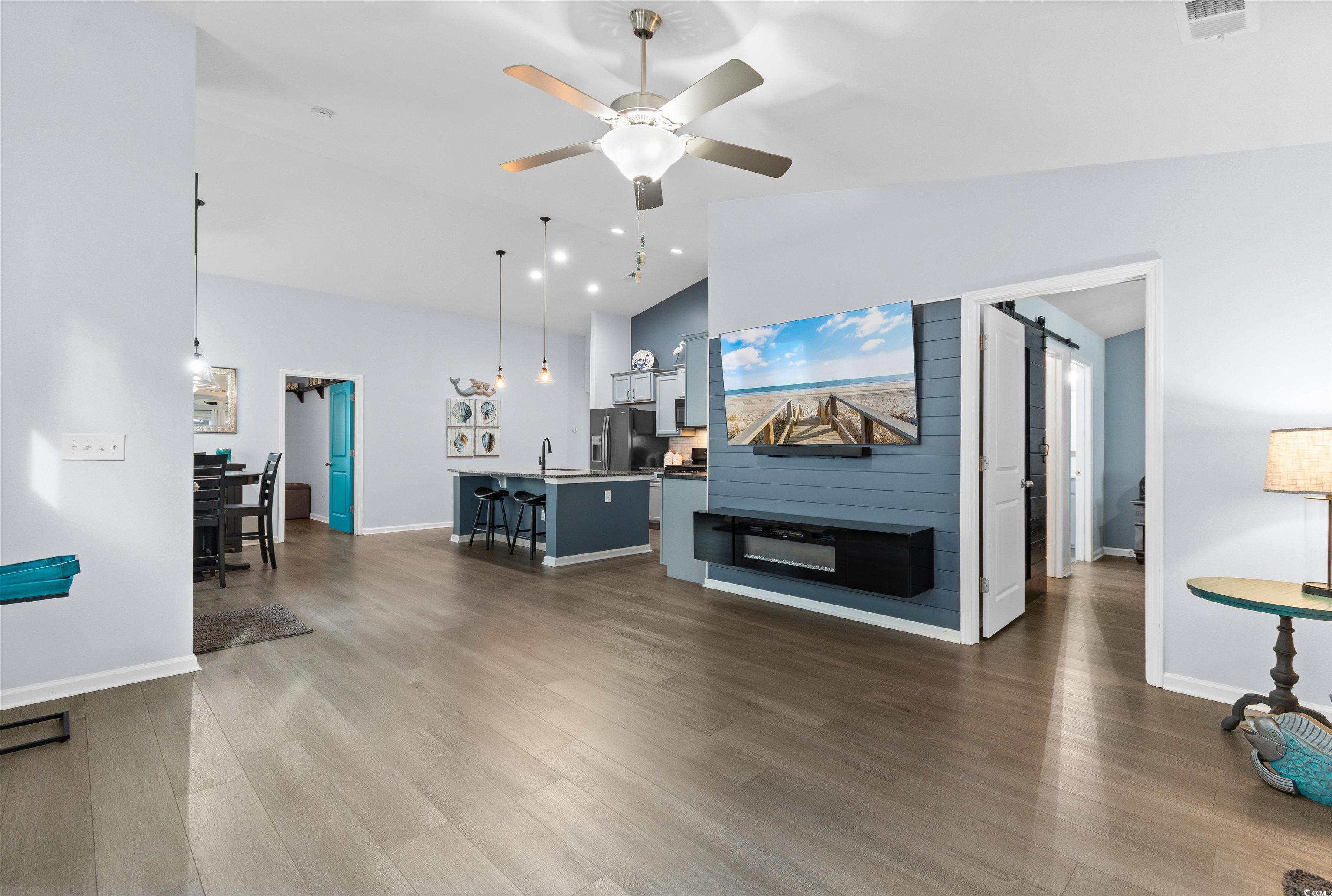 4380 Livorn Loop, Unit 4380 Myrtle Beach, SC 29579 - Photo 10 of 33 Kitchen with range with gas cooktop, pendant lighting, black microwave, light stone counters, and light wood-style floors