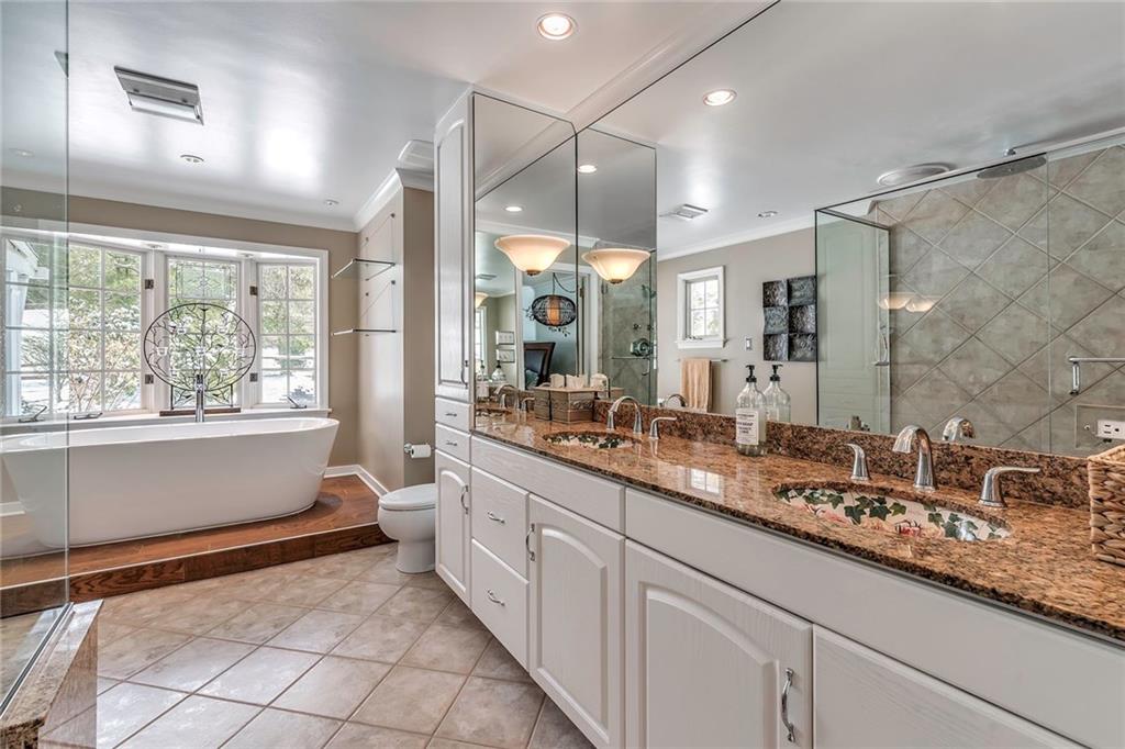 177 Canterbury Road Canonsburg, PA 15317 - Photo 15 of 25 Luxurious master bath with ceramic tile, double bowl vanity with detailed floral painted bowls, walk in glass enclosed shower with rain shower head and free standing bath tub. Plenty of cabinet storage.