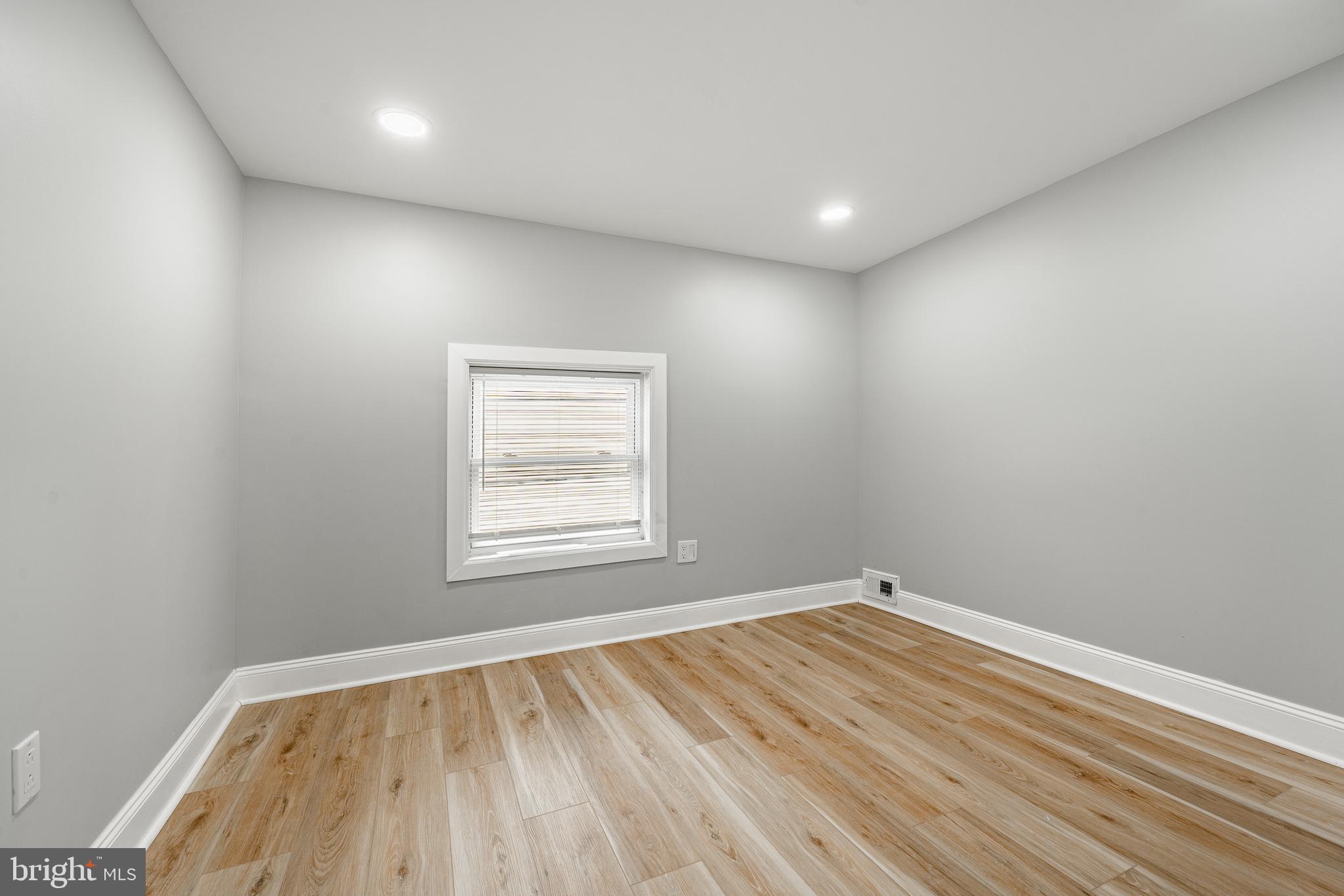 703 Walnut Street Pottstown, PA 19464 - Photo 15 of 24 an empty room with wooden floor and windows