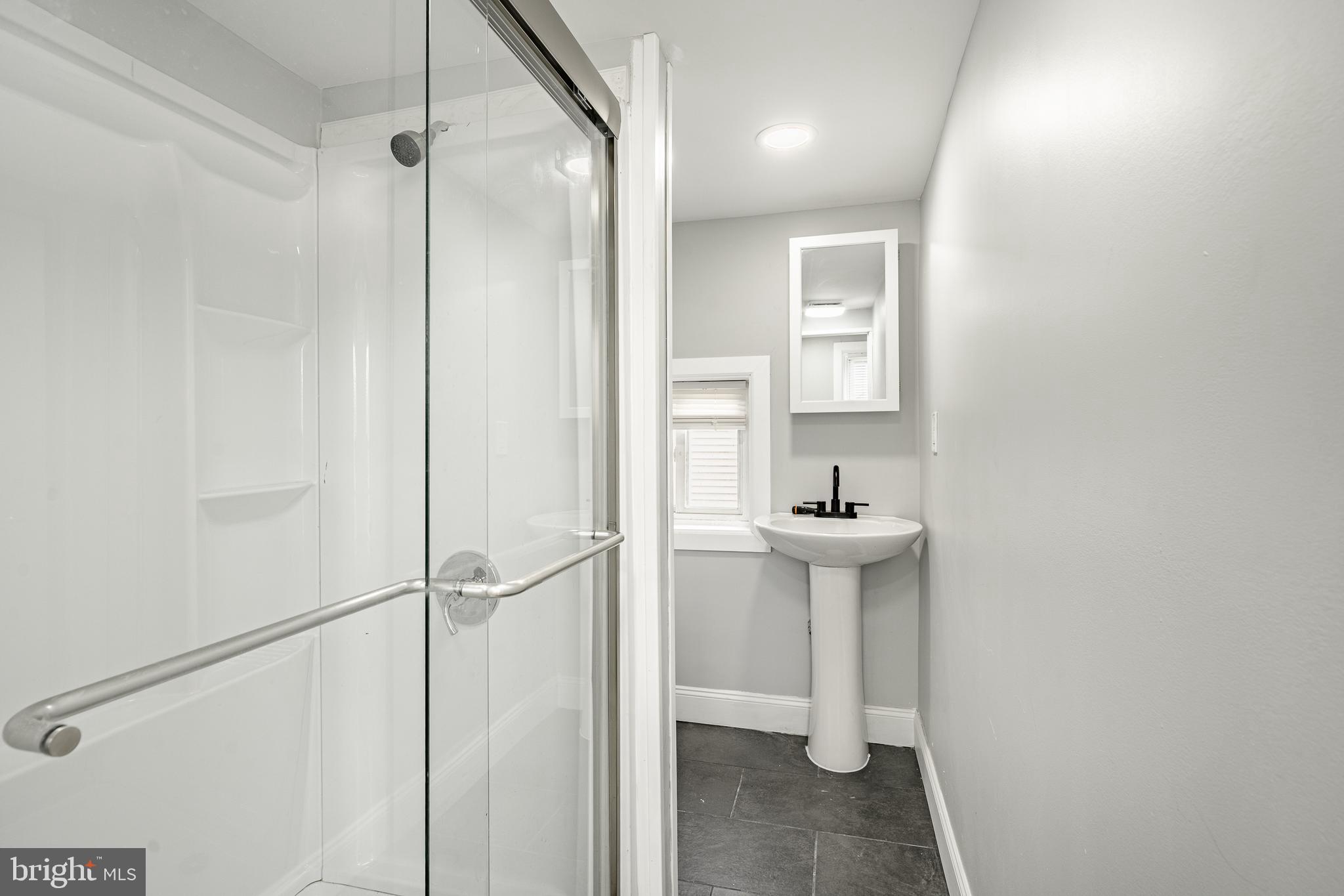 703 Walnut Street Pottstown, PA 19464 - Photo 16 of 24 a bathroom with a sink a toilet a mirror and shower