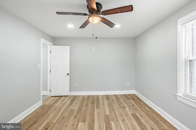 wooden floor in an empty room with a window