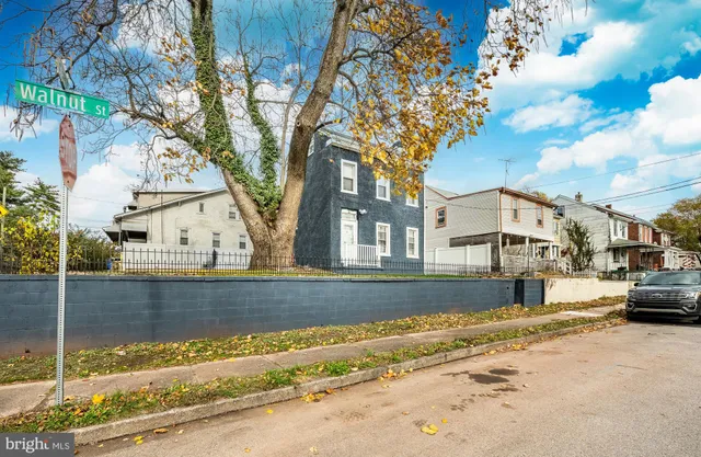 a view of a house with a yard covered with snow in the background
