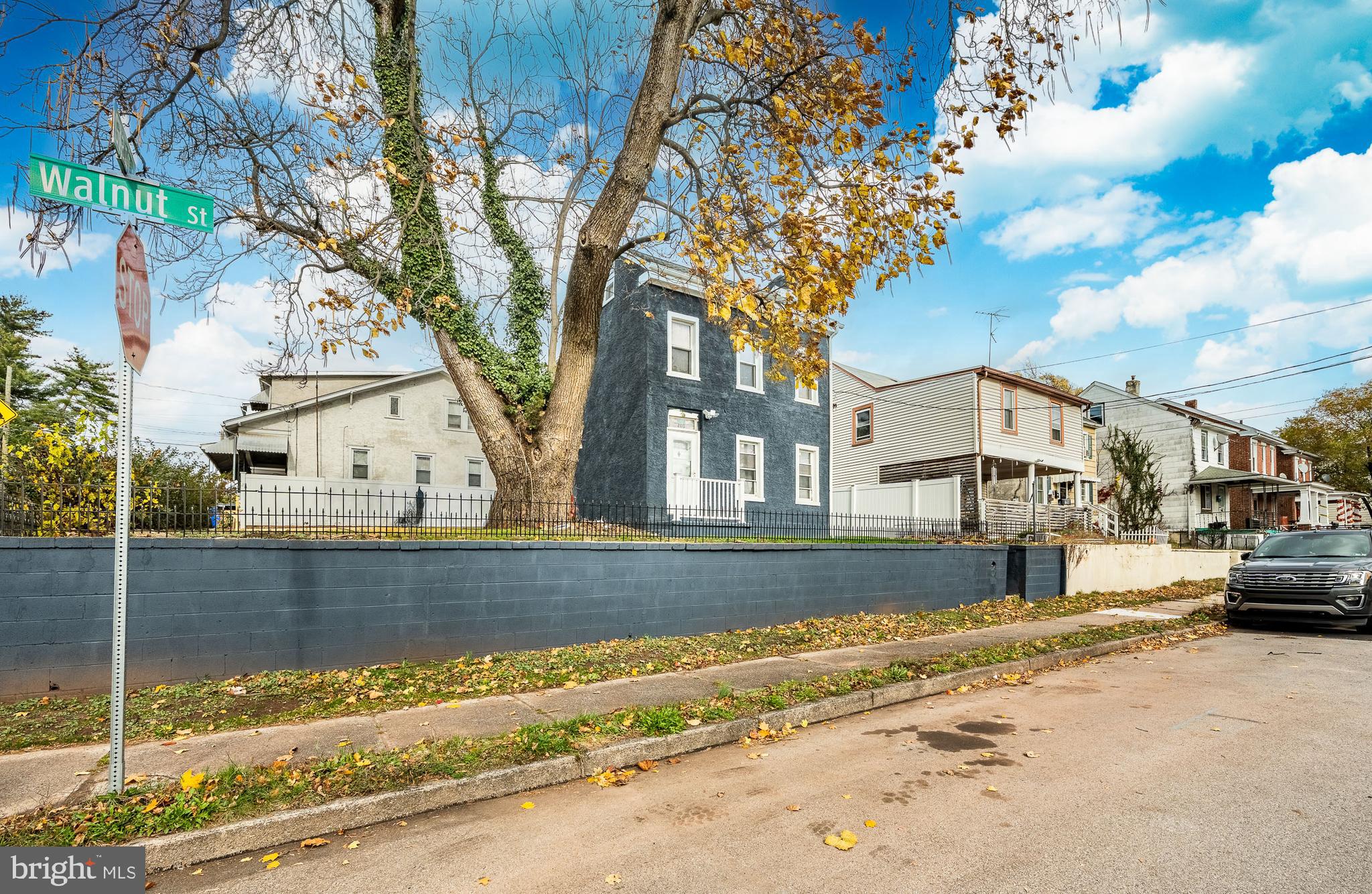 703 Walnut Street Pottstown, PA 19464 - Photo 2 of 24 a view of a house with a yard covered with snow in the background