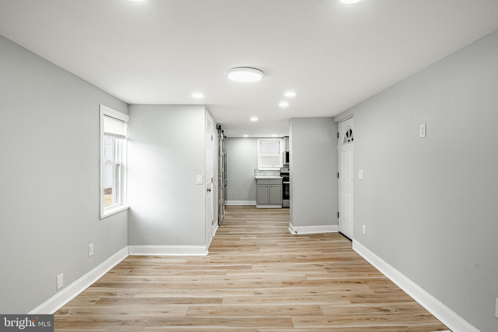 703 Walnut Street Pottstown, PA 19464 - Photo 6 of 24 a view of a big room with wooden floor and windows