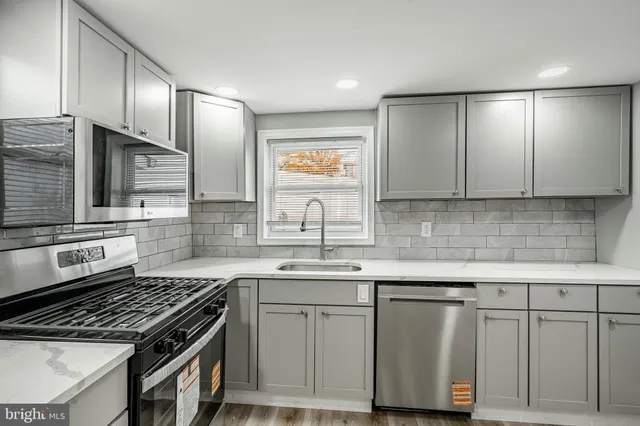 a kitchen with cabinets and appliances