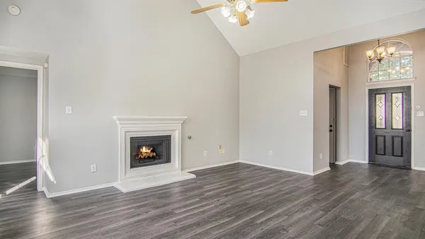 wooden floor fireplace and natural light in room