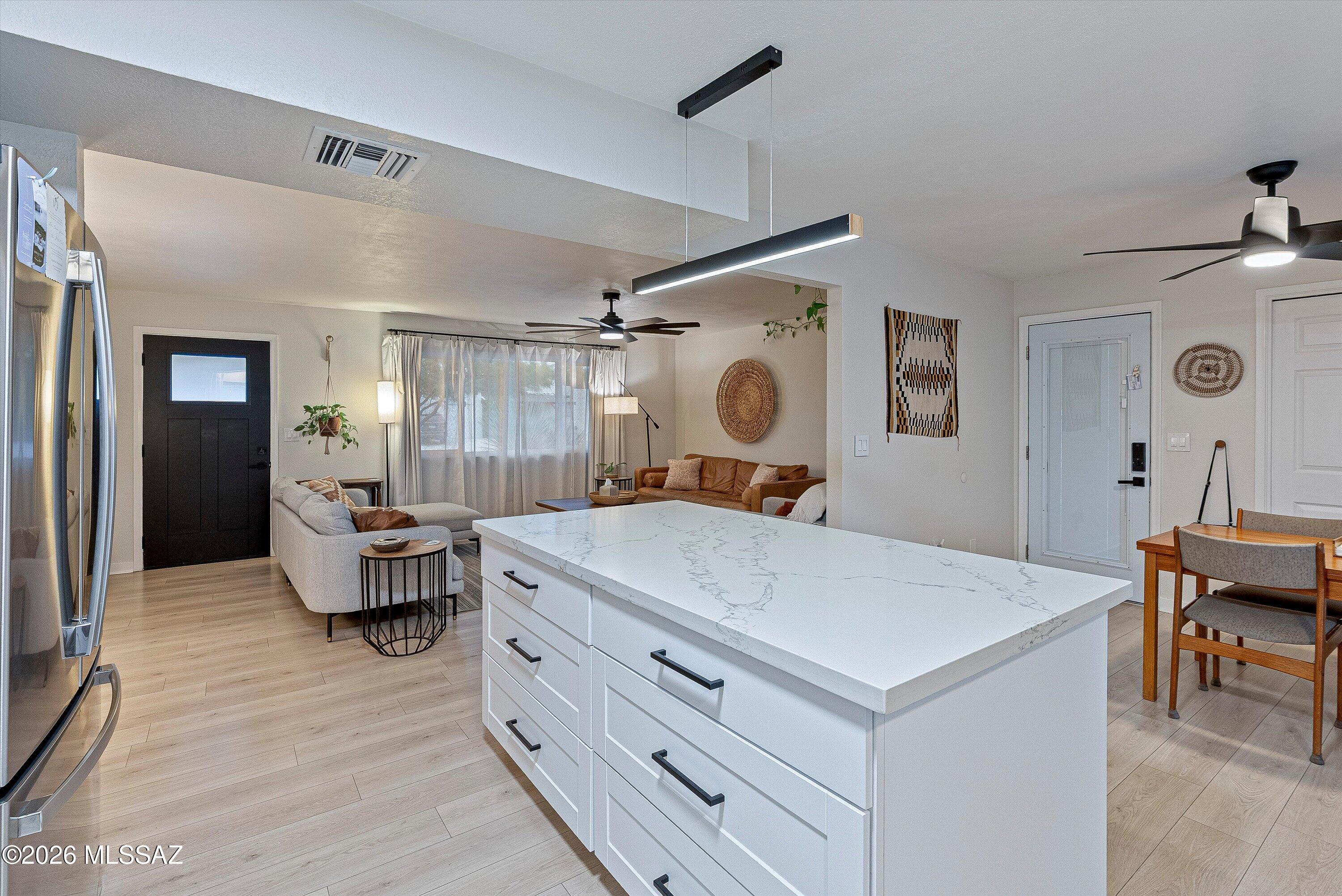 3949 West Mars Street Tucson, AZ 85741 - Photo 23 of 27 a living room with kitchen island furniture and a window