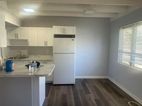 a kitchen with a sink a stove a refrigerator and cabinets