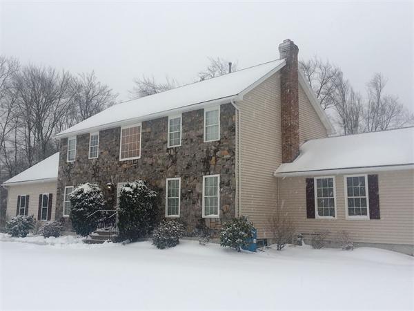 a view of a house with yard and covered with snow