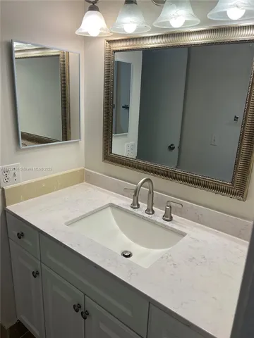 a bathroom with a sink and mirror