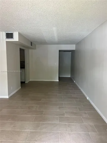 a view of a room with rack on the wall and a window