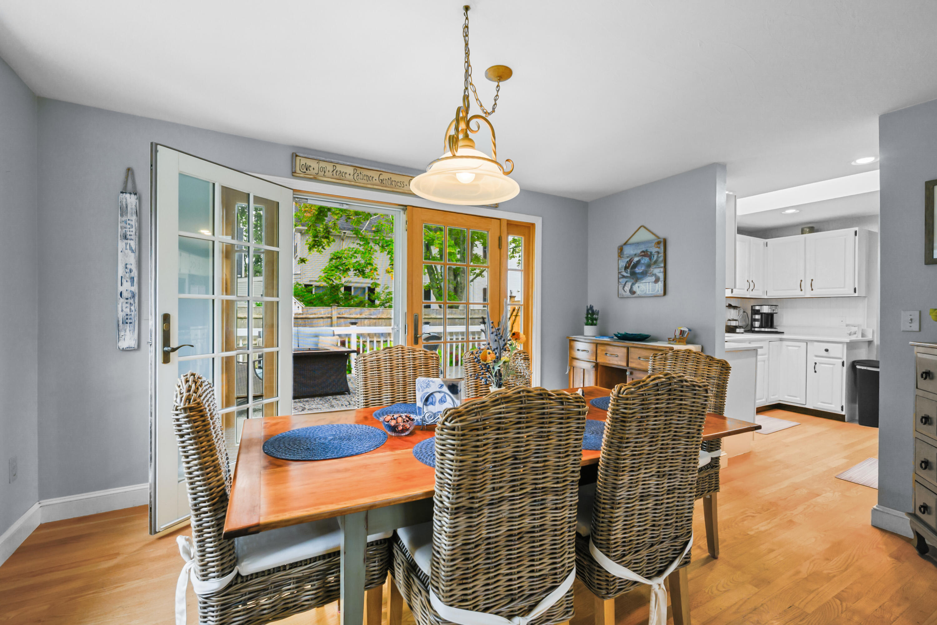 342 Sea Street Hyannis, MA 02601 - Photo 12 of 46 a dining room with furniture a chandelier and wooden floor