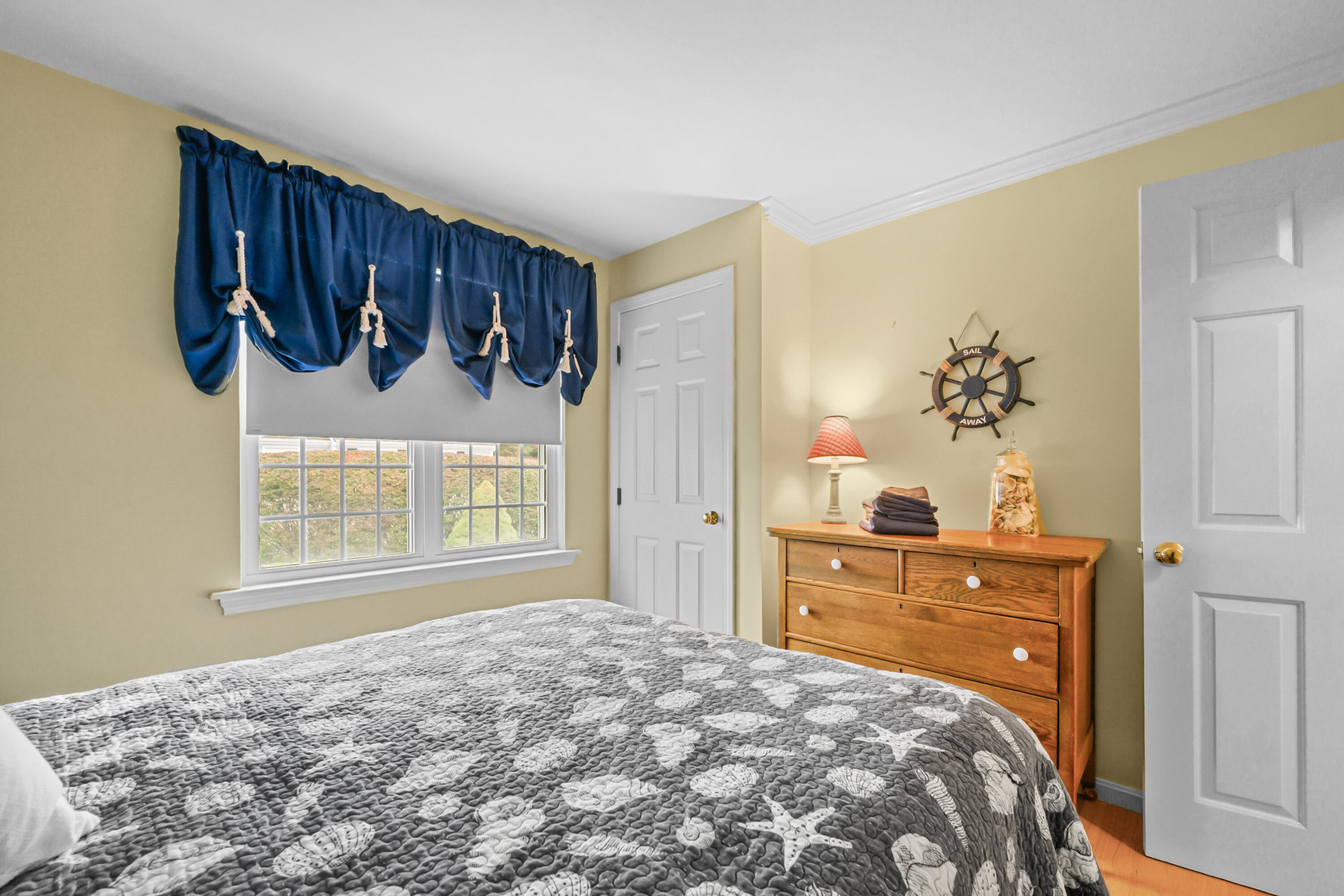 342 Sea Street Hyannis, MA 02601 - Photo 21 of 46 a bedroom with a large bed and a dresser
