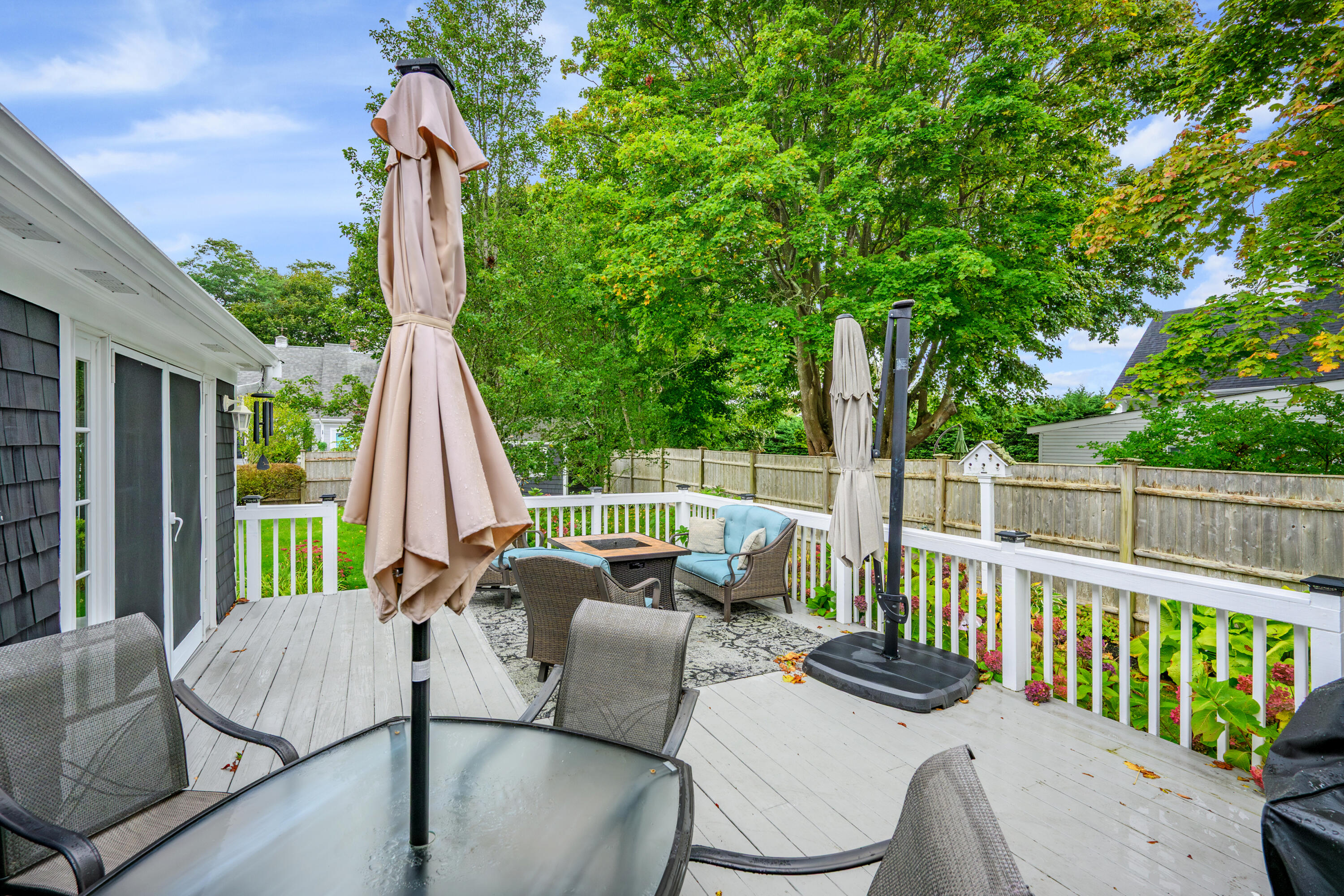 342 Sea Street Hyannis, MA 02601 - Photo 38 of 46 a view of a patio with a table chairs and wooden fence