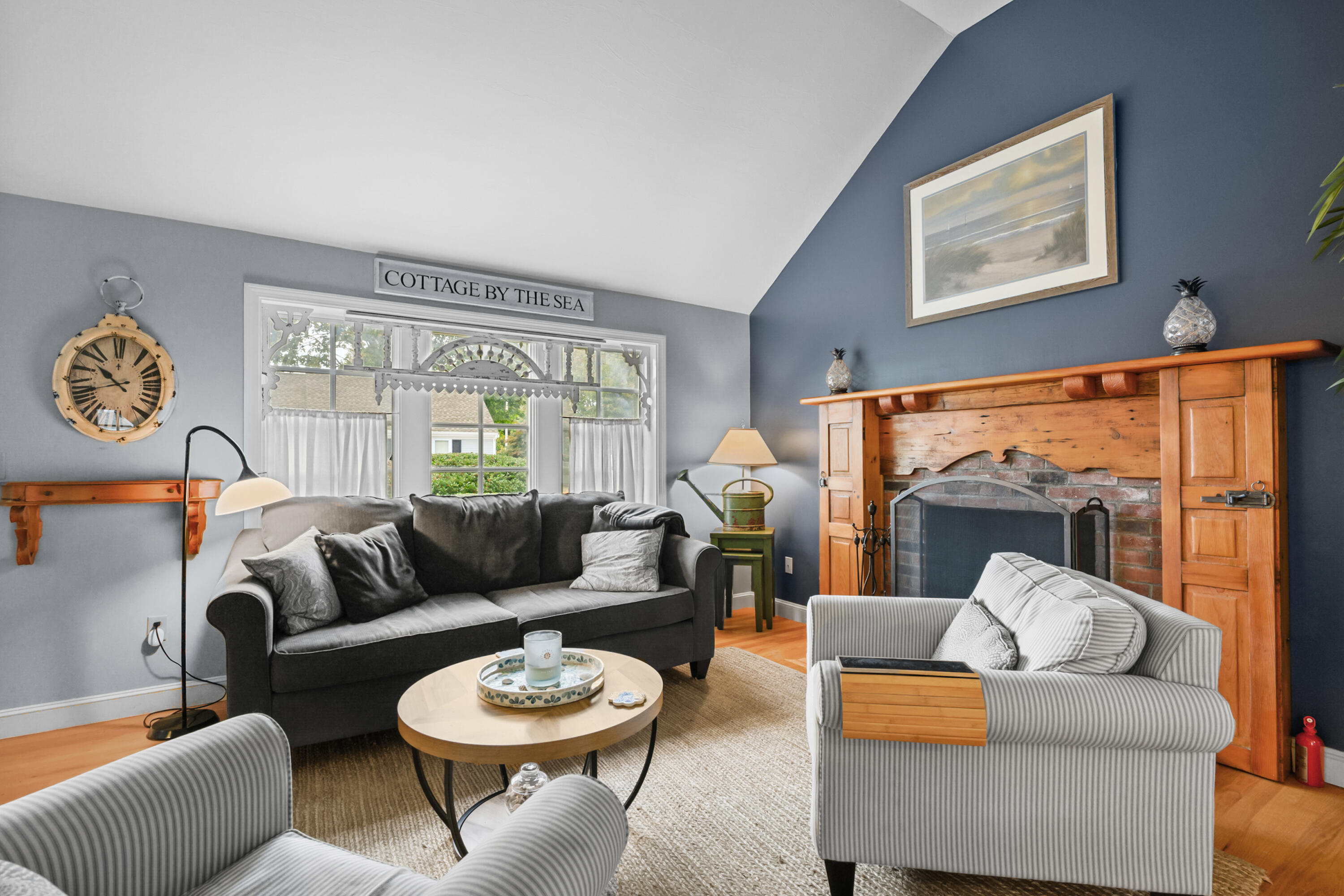 342 Sea Street Hyannis, MA 02601 - Photo 4 of 46 a living room with furniture a fireplace and a large window