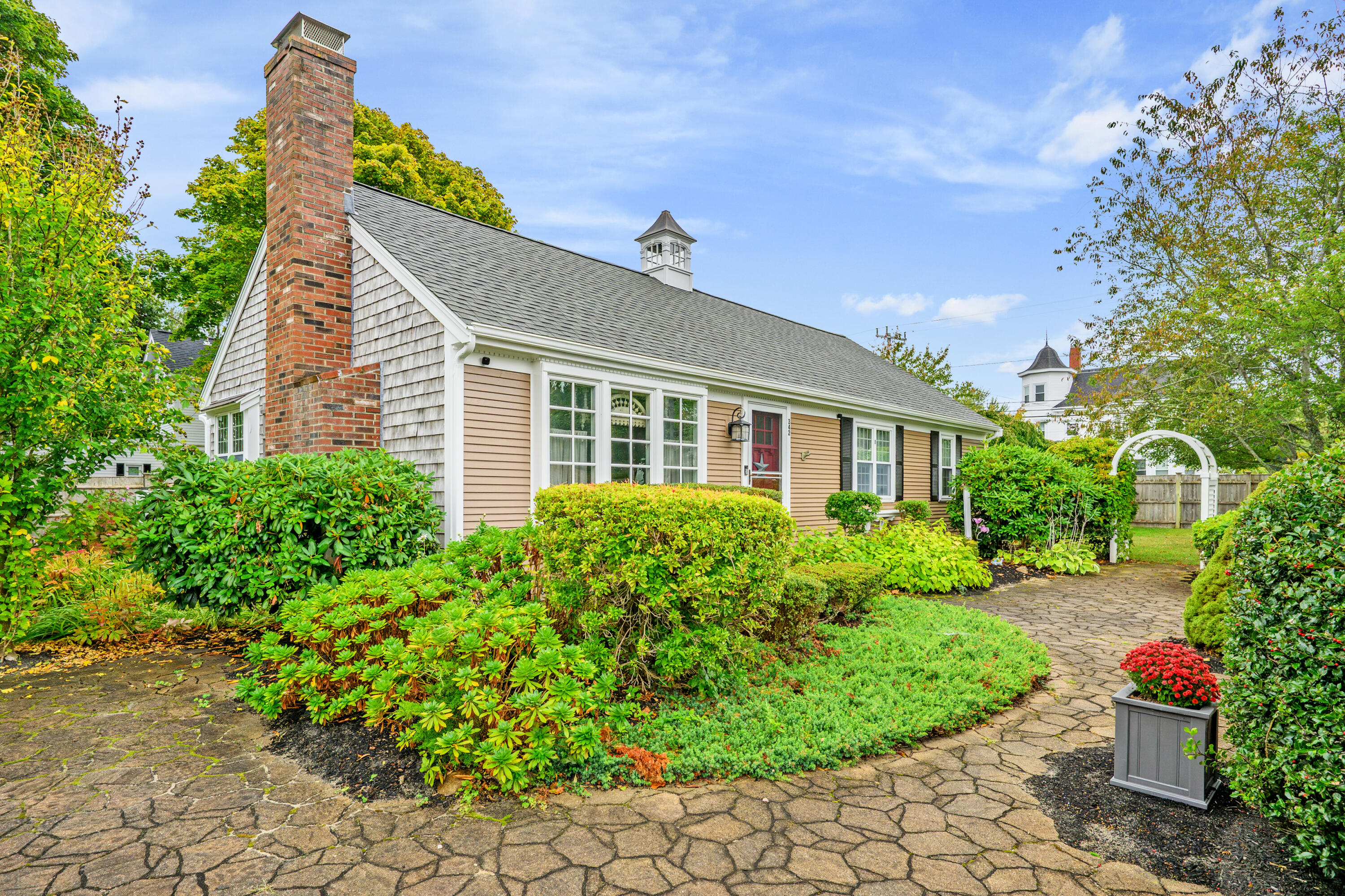 342 Sea Street Hyannis, MA 02601 - Photo 43 of 46 a front view of a house with a yard and potted plants
