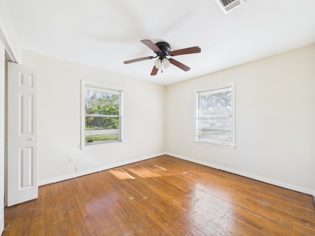 3035 Guese Road Houston, TX 77018 - Photo 11 of 20 a view of a room with wooden floor and a ceiling fan