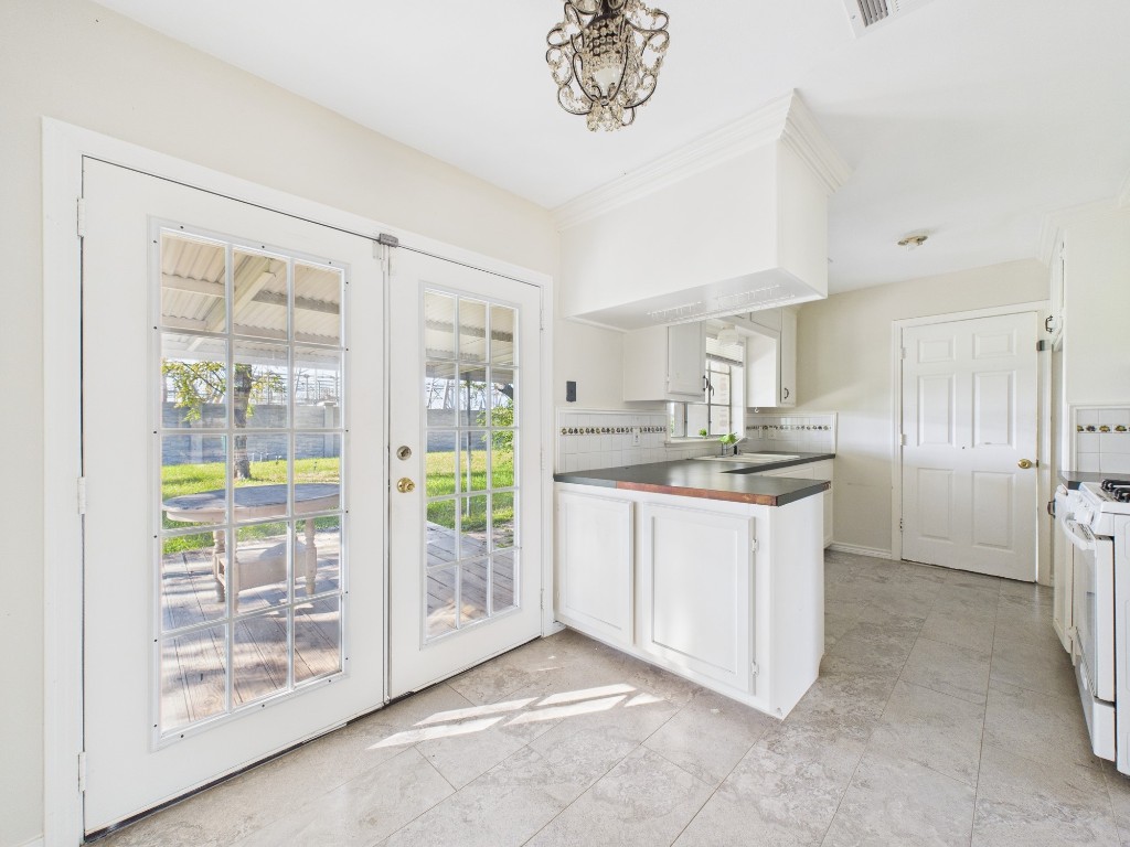3035 Guese Road Houston, TX 77018 - Photo 7 of 20 a kitchen with stainless steel appliances granite countertop a refrigerator a sink a stove top oven a large window with white walls