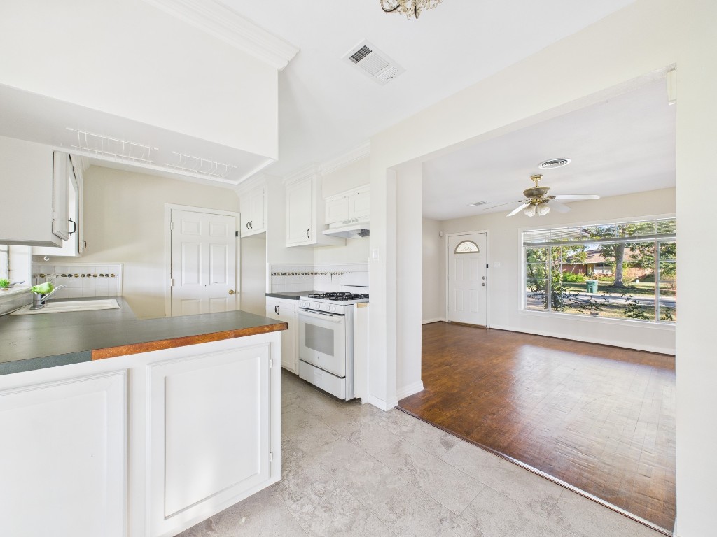 3035 Guese Road Houston, TX 77018 - Photo 8 of 20 a kitchen with white cabinets and appliances