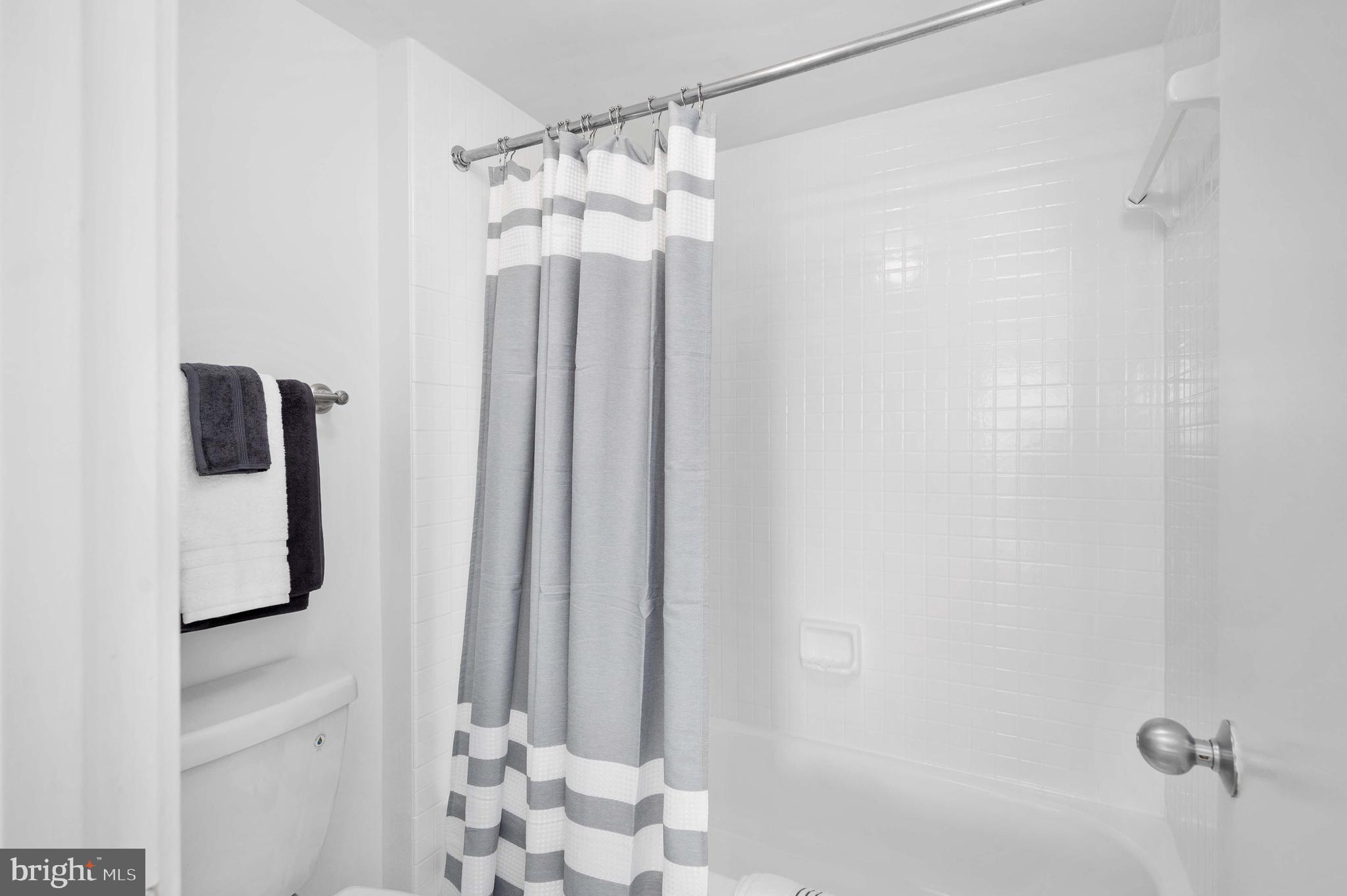 5501 Seminary Road, Unit 511S Falls Church, VA 22041 - Photo 25 of 44 a bathroom with a mirror and a shower curtain
