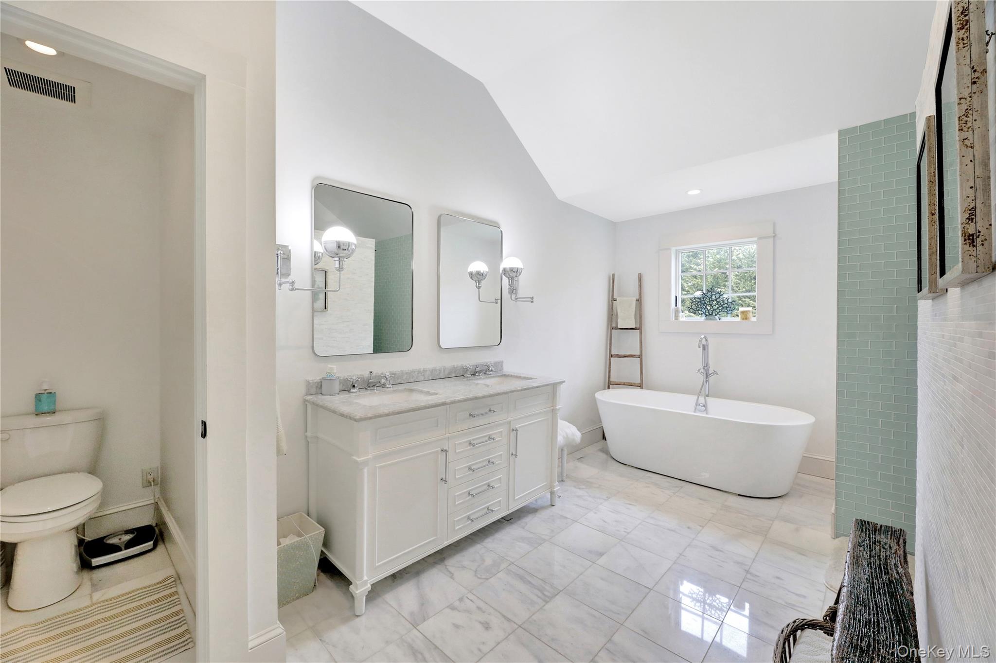 198 South Country Road Remsenburg, NY 11960 - Photo 23 of 49 a spacious bathroom with a granite countertop toilet a sink and a mirror