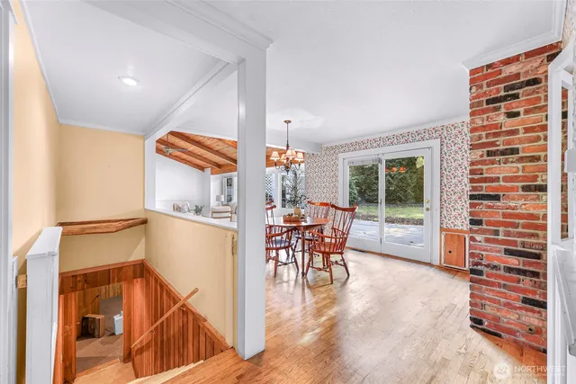 a dining room with a wooden table and chairs