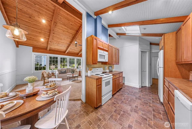 a kitchen with stainless steel appliances kitchen island granite countertop a sink and dishwasher a stove top oven with wooden floor