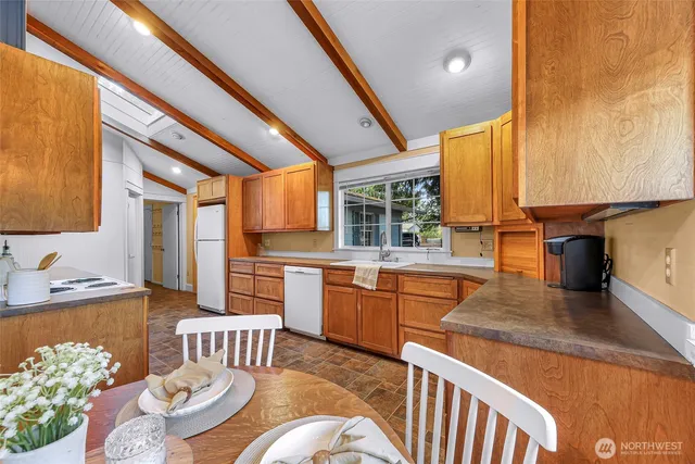 a kitchen with sink cabinets and refrigerator