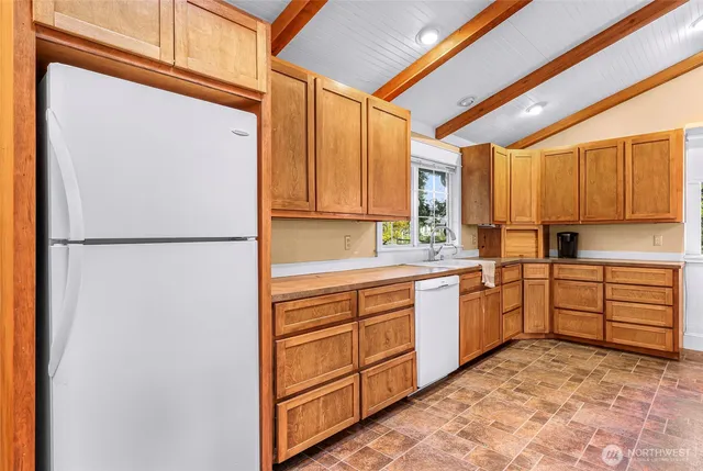 a utility room with cabinets washer and dryer